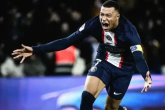 Kylian Mbappé in a PSG kit during a match, representing his crucial role at Paris Saint-Germain amidst ongoing contract negotiations.