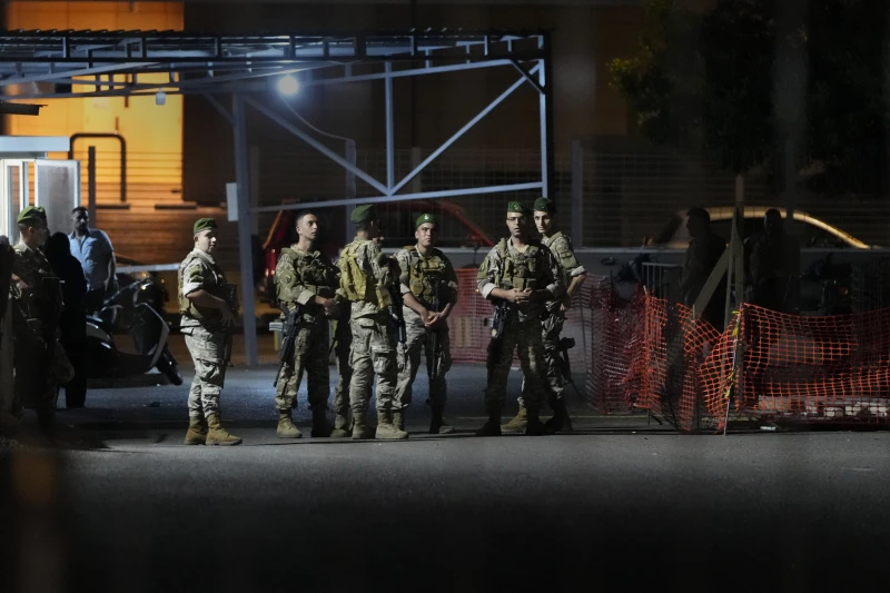 Middle East Conflict: Lebanese soldiers stand guard as their comrades prepare to detonate a walkie-talkie that was found at the parking of the American University Hospital, in Beirut, Lebanon, Wednesday, Sept. 18, 2024.